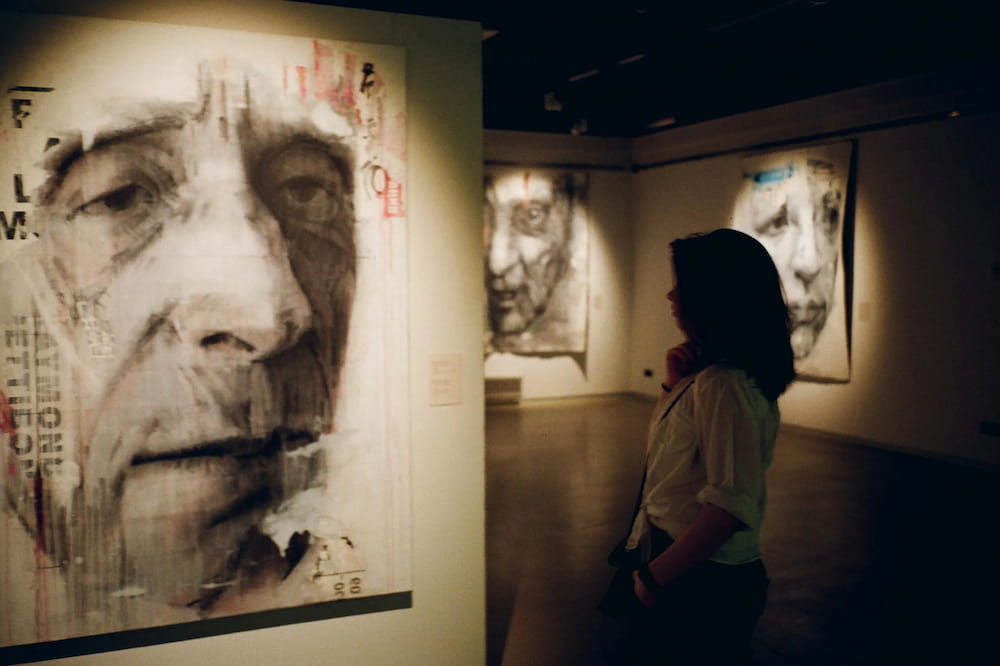 woman viewing fine art painting in art gallery